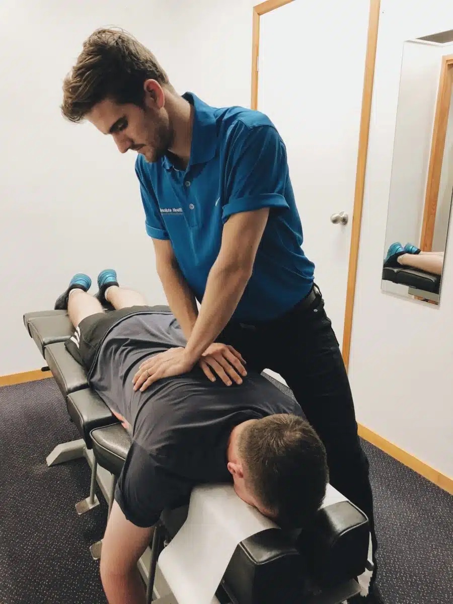 Chiropractor performing spinal adjustment on patient at Absolute Health clinic in Mooloolaba.