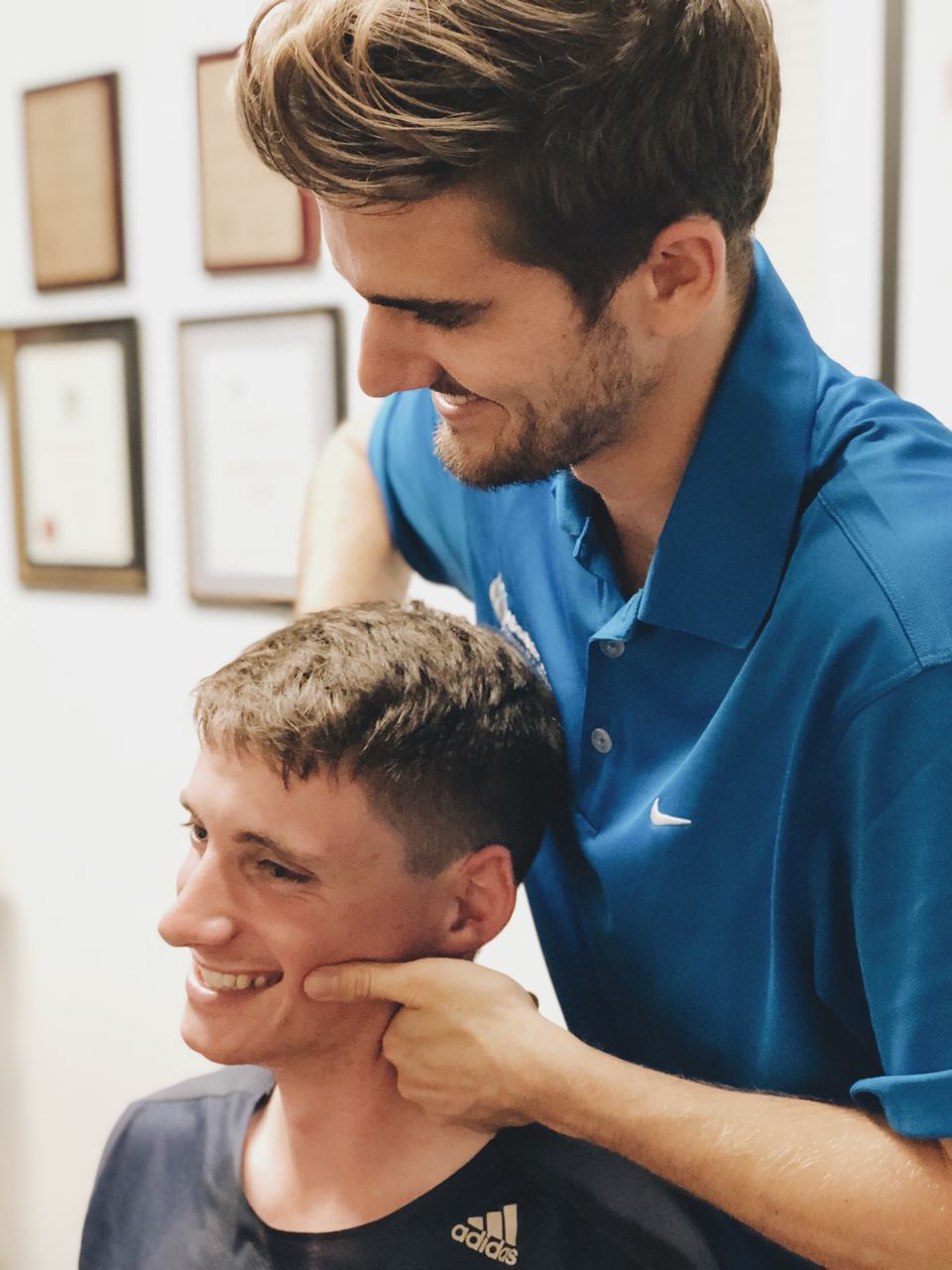 Chiropractor assessing cervical spine of a patient with headaches at Absolute Health